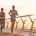 Two joggers running on a bridge, demonstrating health and fitness for a marathon.
